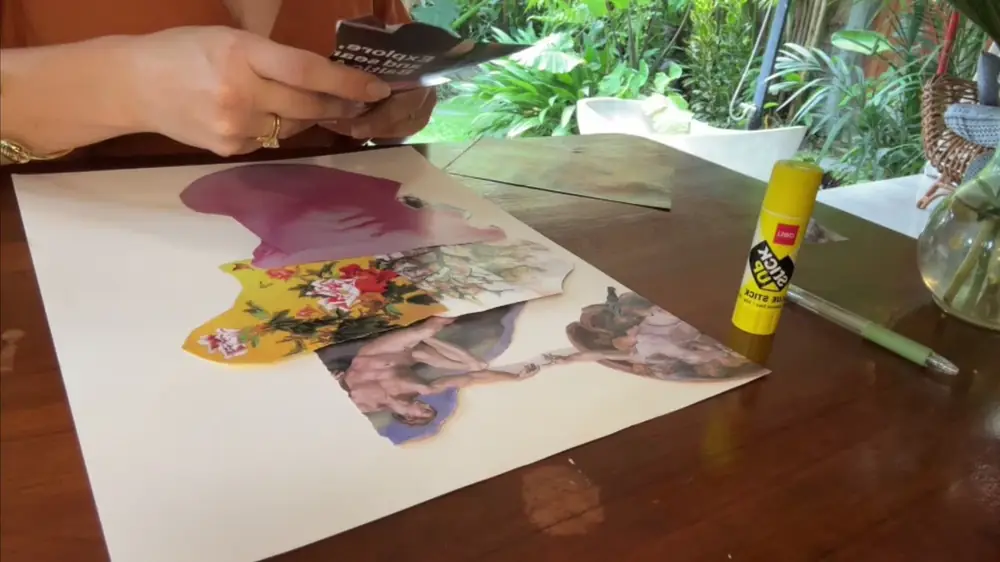 Ana's hands arranging collage pieces